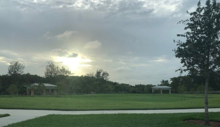 Green parkland with pavilions at Hillsboro El Rio Park in South Boca Raton